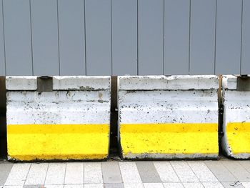 Yellow wall by footpath