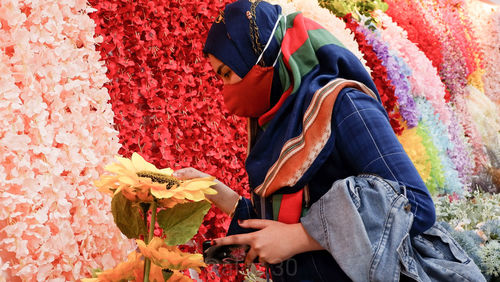 Midsection of man holding flower bouquet