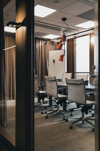 Empty board room seen through doorway in office