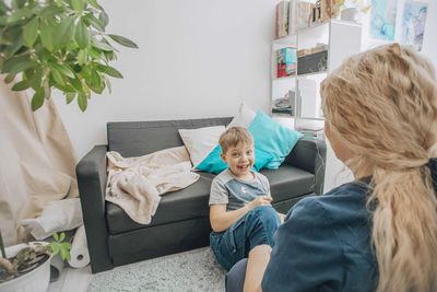 Therapist teaching hand coordination exercises to boy, session, sensory integration, psychology
