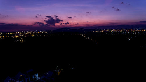 High angle view of illuminated city buildings at night