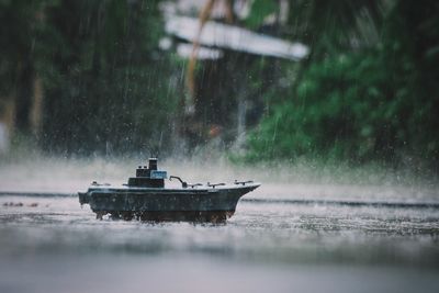 Ship sailing in water during rainy season