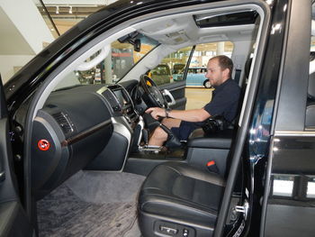 Man analyzing car in showroom