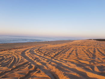 Scenic view of beach against clear sky