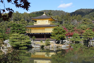 Built structure with trees in lake