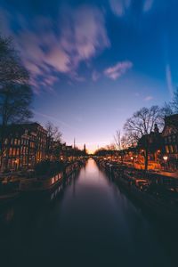 High angle view of canal against sky during sunset in city