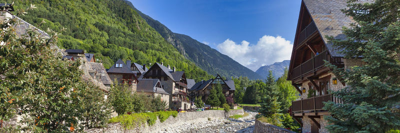 Panoramic view of buildings and mountains against sky