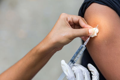 Close-up of doctor giving injection to patient