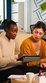 Portrait of young woman using laptop at home