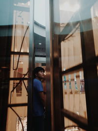 Man looking through window in building