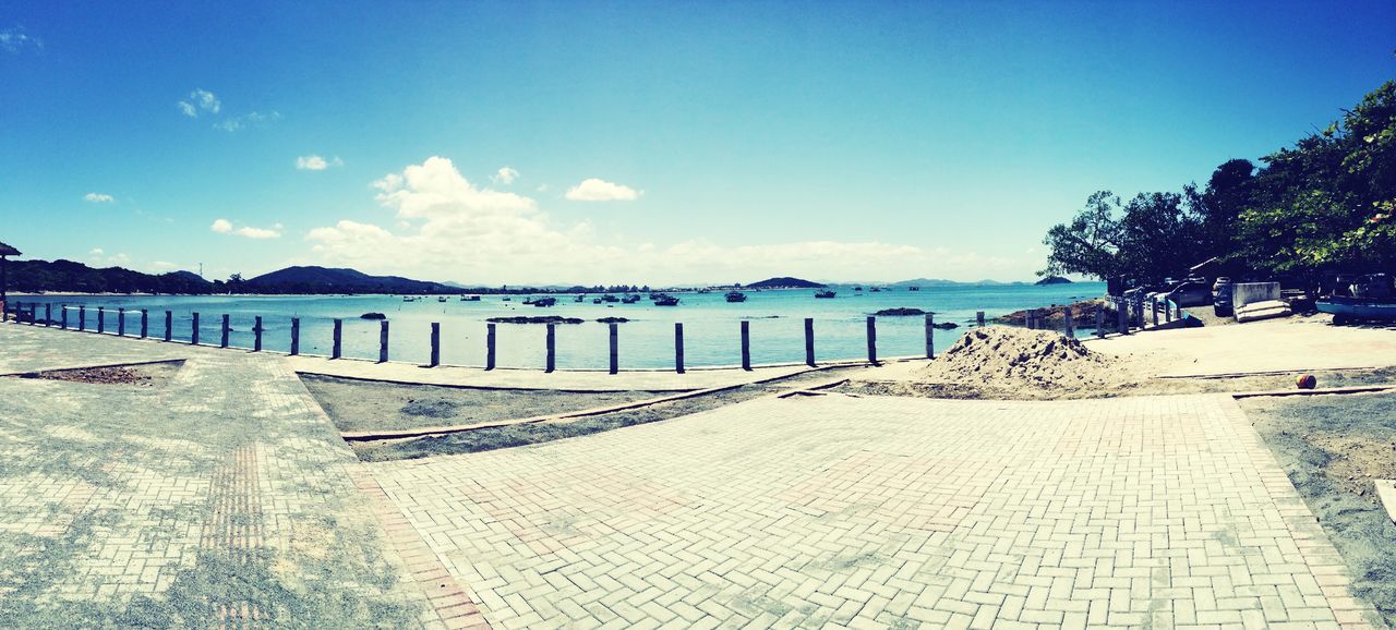 water, sea, sky, tranquility, tranquil scene, blue, beach, scenics, built structure, nature, railing, sunlight, beauty in nature, shadow, tree, day, the way forward, horizon over water, architecture, cloud