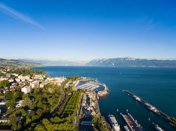 High angle view of city by sea against sky