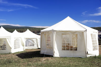 Tent on field against sky