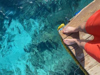 Low section of woman swimming in sea