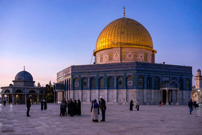 People at masjidil aqsa mosque against clear sky