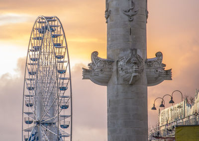 Ferris wheel at amusement park during sunset