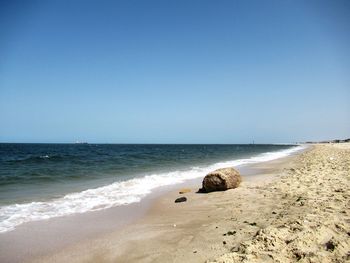Scenic view of beach against clear sky