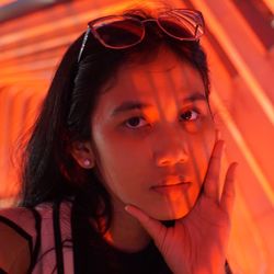 Close-up portrait of woman with hand on chin