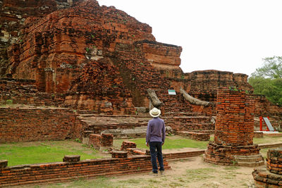 Full length rear view of man standing at temple
