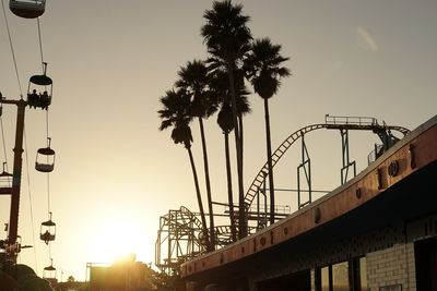 Low angle view of silhouette palm trees against clear sky