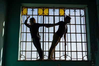 Man looking through window