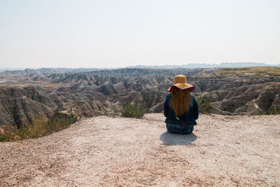 Woman wearing hat against mountains against clear sky