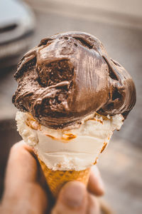 Cropped hand holding ice cream cone