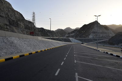 Road by mountain against clear sky