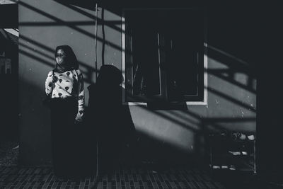 Rear view of women standing at home