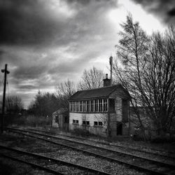 Railroad track against cloudy sky