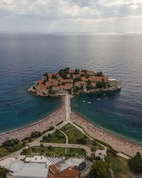 High angle view of sea and buildings against sky