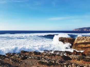Scenic view of sea against blue sky
