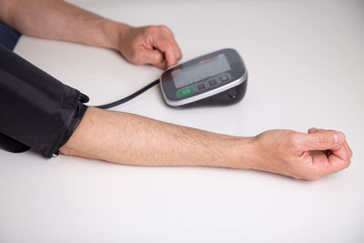 Cropped image of man holding thermometer