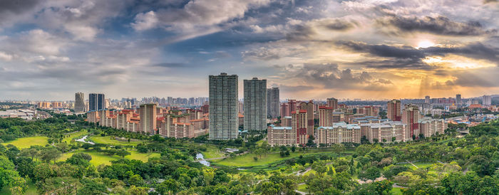 View of cityscape against cloudy sky