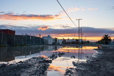 Scenic view of lake against sky at sunset