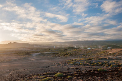 Aerial view of landscape against cloudy sky during sunset