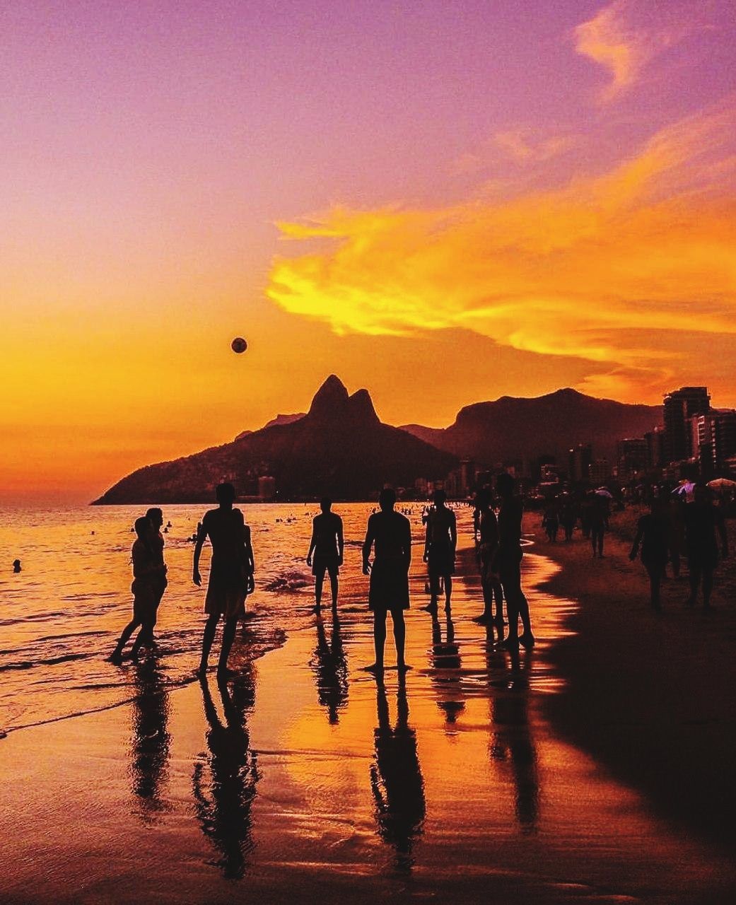 sunset, sky, real people, orange color, water, beach, group of people, men, land, nature, leisure activity, silhouette, sea, large group of people, crowd, lifestyles, beauty in nature, enjoyment, outdoors