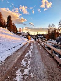 Snow covered road against sky during winter