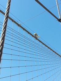 Low angle view of cables against blue sky