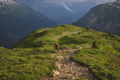 Young male hikes up to aiguillette des posettes, chamonix, france