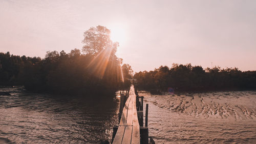 Scenic view of river against sky during sunset