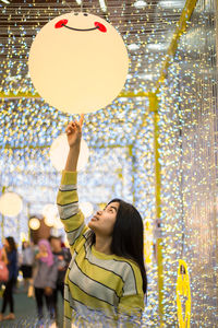 Portrait of a smiling young woman with balloons
