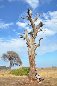 Woman and bare tree