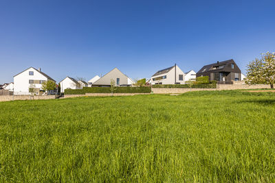 Germany, baden-wurttemberg, ostfildern, new development area with green grass in foreground