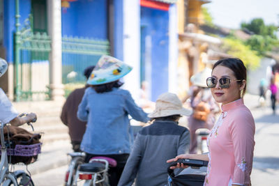 Woman with vietnam culture traditional dress walking at ancient town hoi an vietnam.