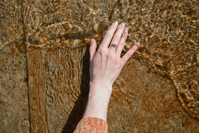 Close-up of hand touching water