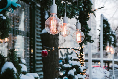 Illuminated christmas decoration hanging outside house during winter 