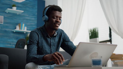 Young man using laptop at office