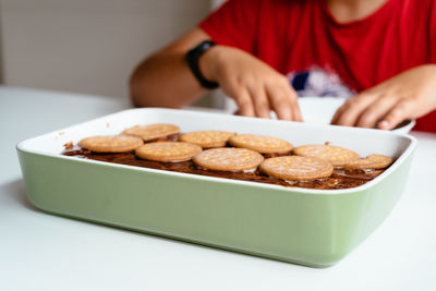 Midsection of man having dessert at table