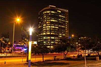 Illuminated buildings against sky at night